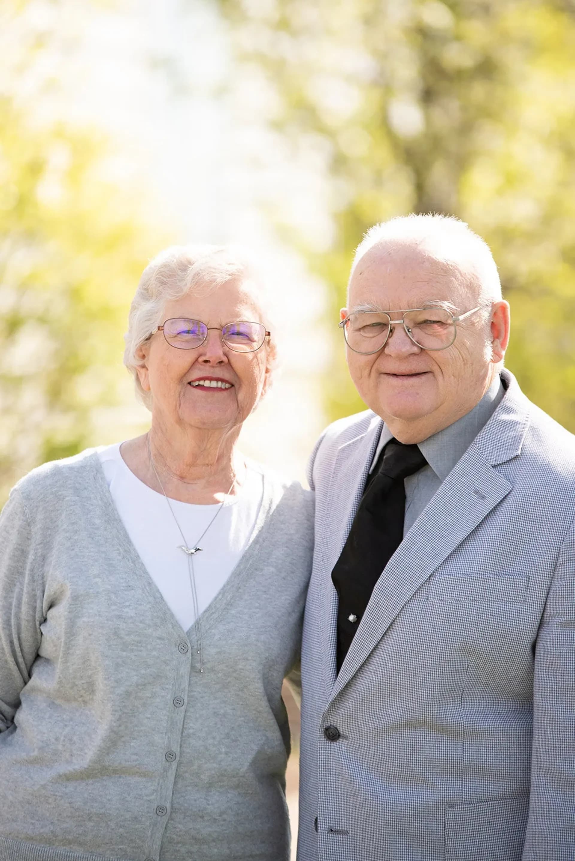 Elderly couple standing in the yard of Sharon RP Church smiling